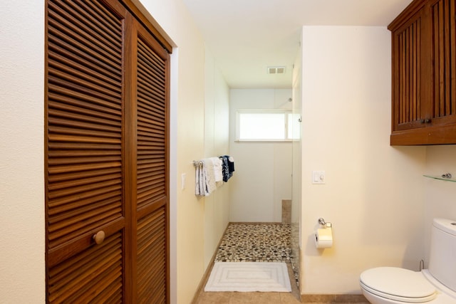 bathroom featuring tile patterned floors and toilet