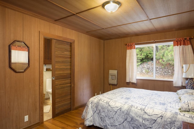 bedroom featuring hardwood / wood-style floors, a closet, and wooden ceiling