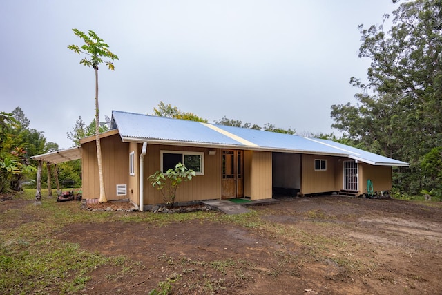 ranch-style home featuring a carport