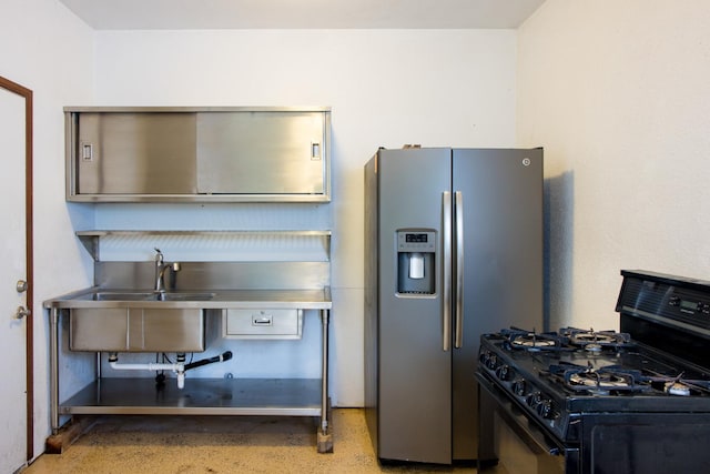 kitchen featuring stainless steel fridge, sink, and black range with gas cooktop