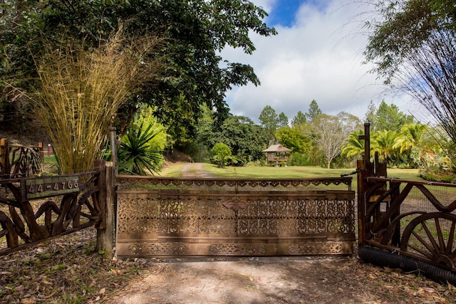 view of gate featuring a yard