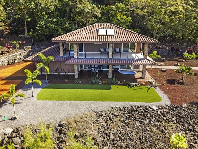 exterior space with a lawn and a balcony