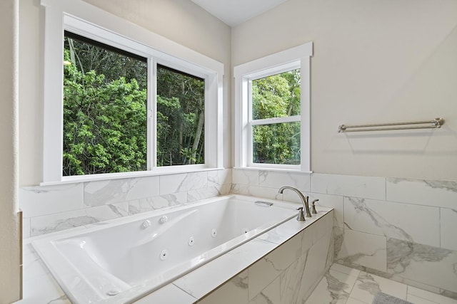 bathroom featuring tiled bath