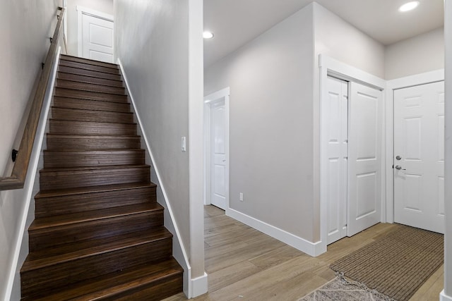 stairs featuring hardwood / wood-style floors