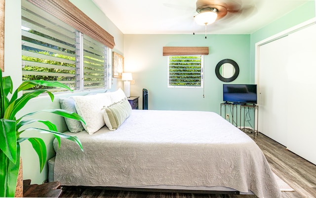 bedroom with ceiling fan and wood-type flooring