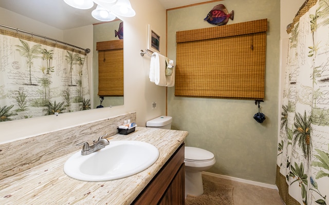 bathroom featuring tile floors, large vanity, and toilet