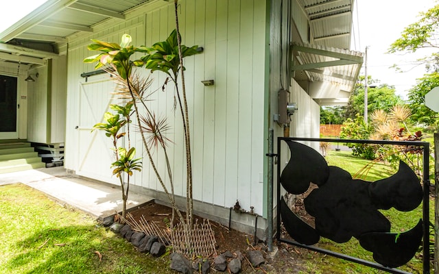 view of side of home with a lawn