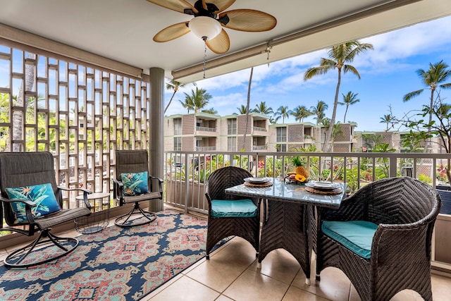 sunroom with a healthy amount of sunlight and ceiling fan