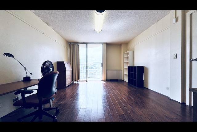 office space featuring a textured ceiling, floor to ceiling windows, and dark hardwood / wood-style floors