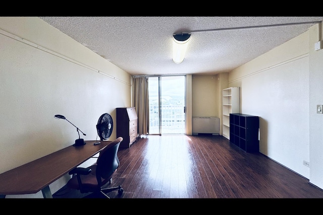 office area featuring expansive windows, dark hardwood / wood-style flooring, and a textured ceiling