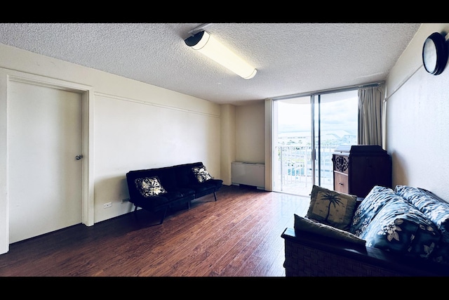 sitting room with a textured ceiling, dark hardwood / wood-style flooring, and floor to ceiling windows