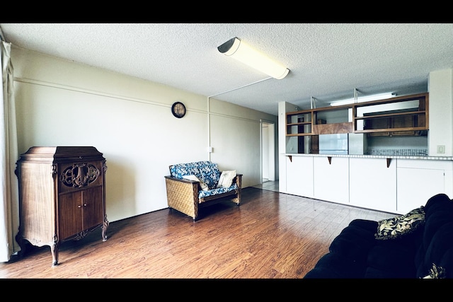 interior space with hardwood / wood-style flooring and a textured ceiling