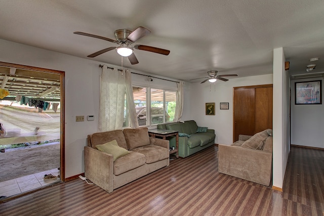 living room featuring dark hardwood / wood-style flooring and ceiling fan