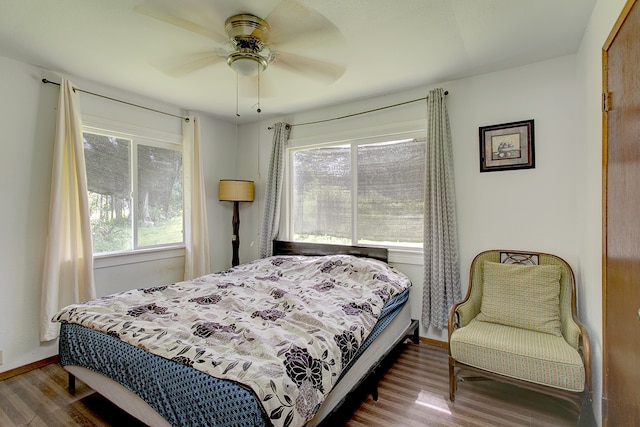 bedroom with dark wood-type flooring and ceiling fan