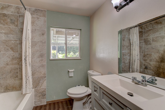 full bathroom with toilet, vanity, hardwood / wood-style flooring, and shower / tub combo