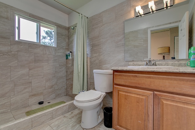 bathroom with tile flooring, tile walls, a shower with shower curtain, toilet, and vanity