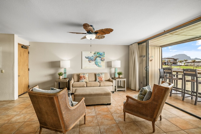 living room with ceiling fan and light tile patterned floors