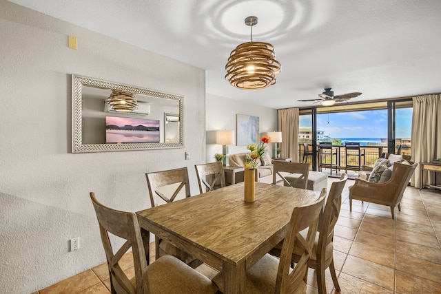 dining area with light tile patterned flooring, expansive windows, and ceiling fan