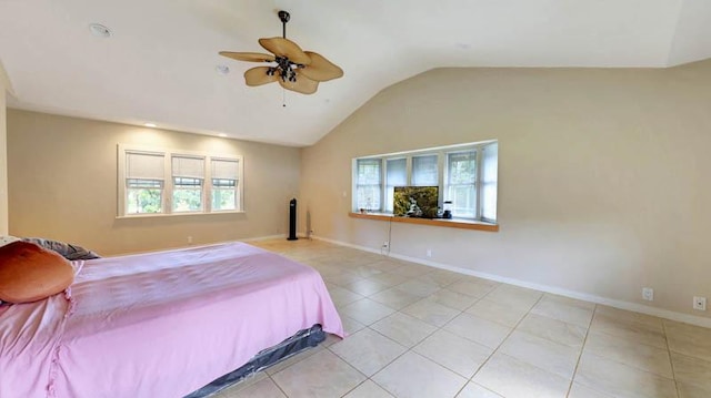 bedroom with ceiling fan, light tile patterned floors, and vaulted ceiling