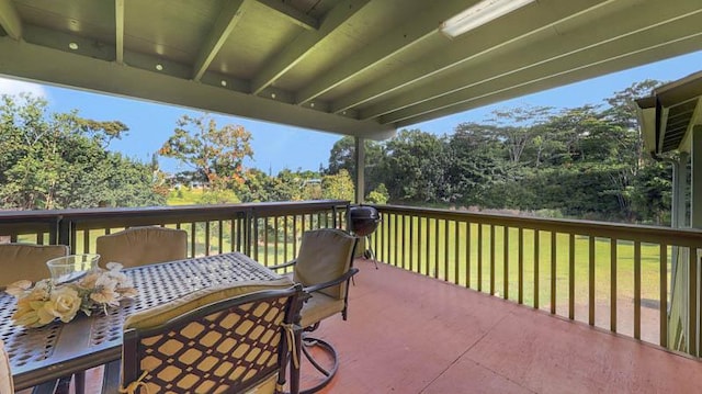 wooden deck featuring a lawn