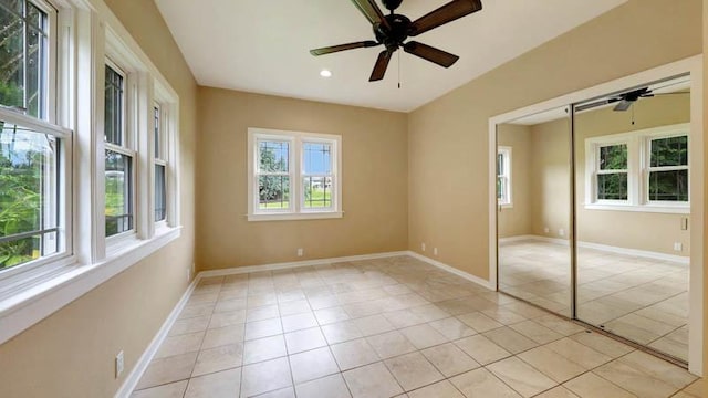 unfurnished bedroom with ceiling fan, a closet, and light tile patterned floors