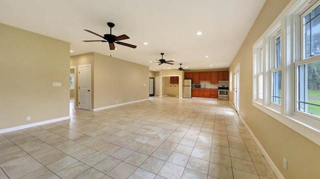 unfurnished living room featuring ceiling fan and light tile patterned flooring