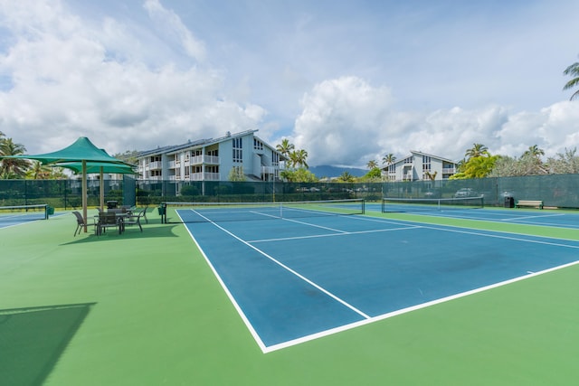 view of tennis court featuring basketball court