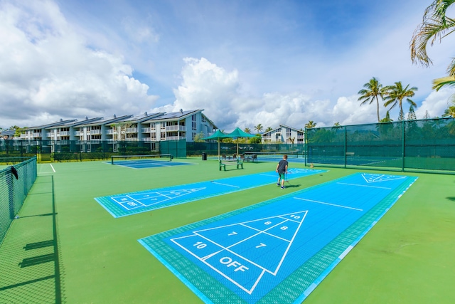 view of property's community featuring tennis court