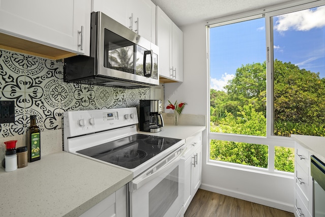 kitchen featuring white cabinetry, wood-type flooring, a textured ceiling, and white electric stove