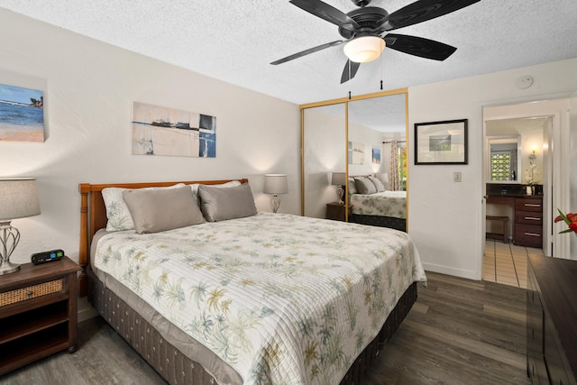 bedroom with a textured ceiling, ceiling fan, a closet, and dark hardwood / wood-style floors