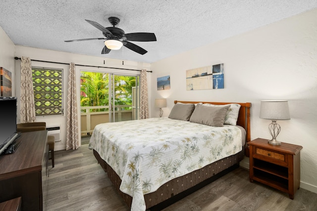 bedroom with a textured ceiling, ceiling fan, and dark wood-type flooring