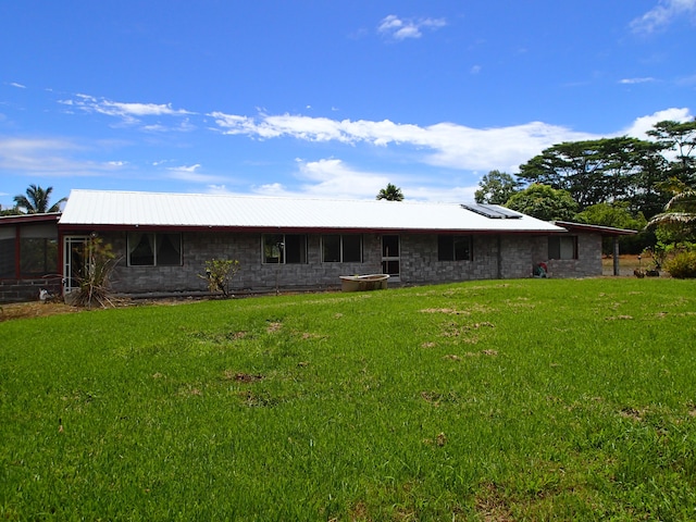 rear view of house with a lawn