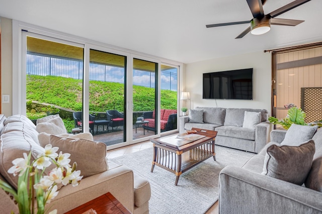 living room with ceiling fan and light tile patterned floors