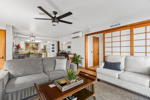 living room featuring carpet flooring, ceiling fan with notable chandelier, and a wall mounted AC