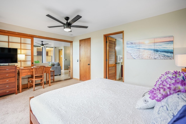 carpeted bedroom featuring two closets and ceiling fan