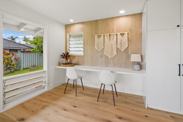 office featuring built in desk and wood-type flooring