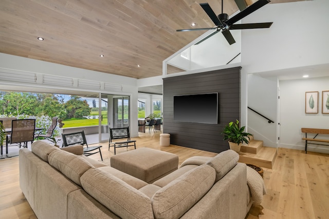 living room with ceiling fan, light wood-type flooring, and wood ceiling