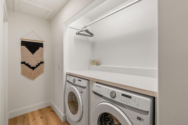 washroom with washer and clothes dryer and light hardwood / wood-style flooring