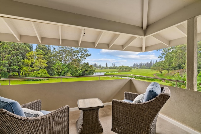 view of patio with a balcony and a water view