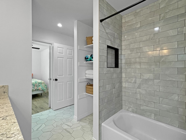 bathroom with vanity, tiled shower / bath, and tile patterned floors