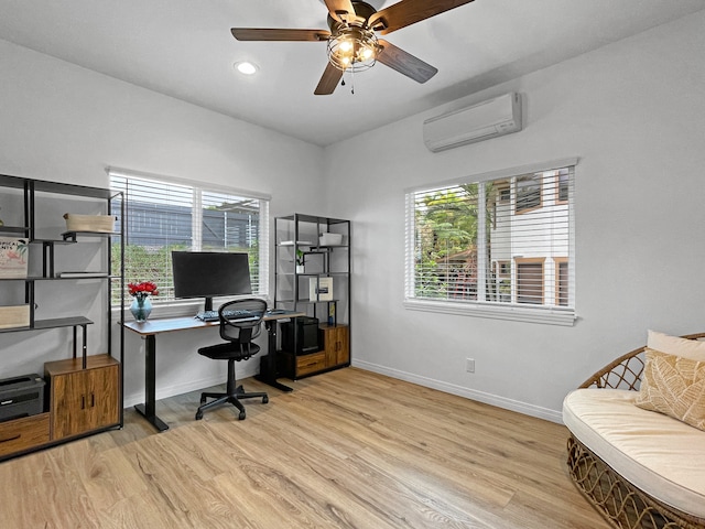 office with plenty of natural light, a wall mounted air conditioner, light wood-type flooring, and ceiling fan