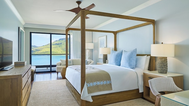 bedroom with a water view, access to outside, ceiling fan, crown molding, and hardwood / wood-style floors