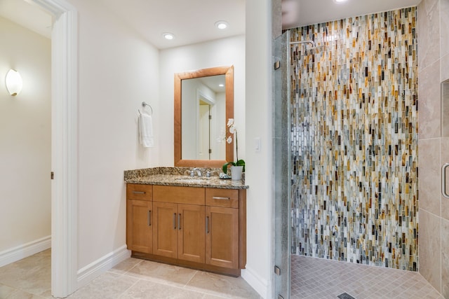 bathroom featuring tile patterned floors, vanity, and a shower with shower door