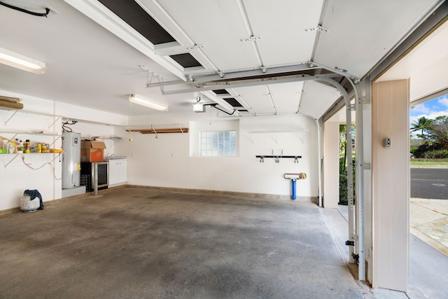 garage featuring water heater and a garage door opener