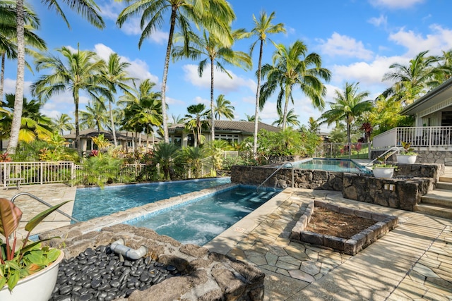 view of pool with an in ground hot tub and a patio