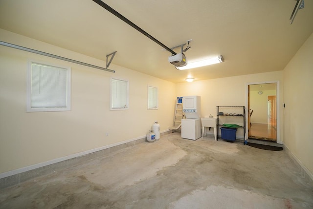 garage featuring washer / dryer, a garage door opener, and sink