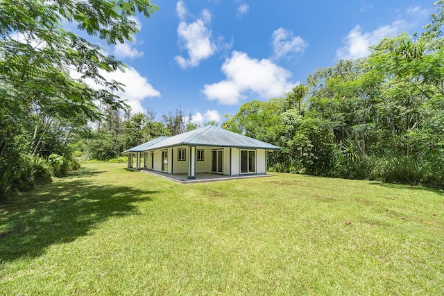 rear view of house with a lawn