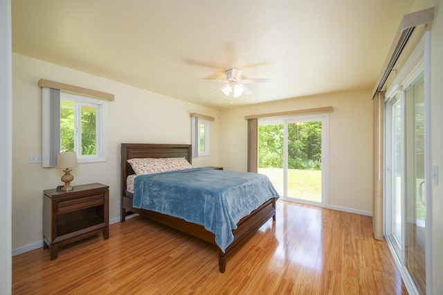 bedroom with ceiling fan, light hardwood / wood-style floors, multiple windows, and access to outside