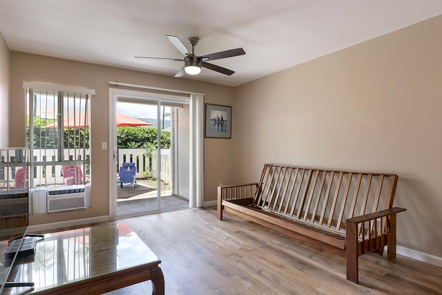 bedroom featuring hardwood / wood-style flooring, ceiling fan, cooling unit, and access to outside