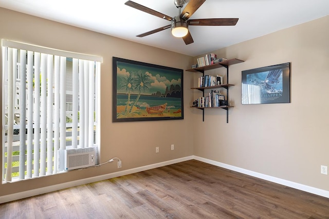 unfurnished room featuring hardwood / wood-style floors, ceiling fan, and cooling unit